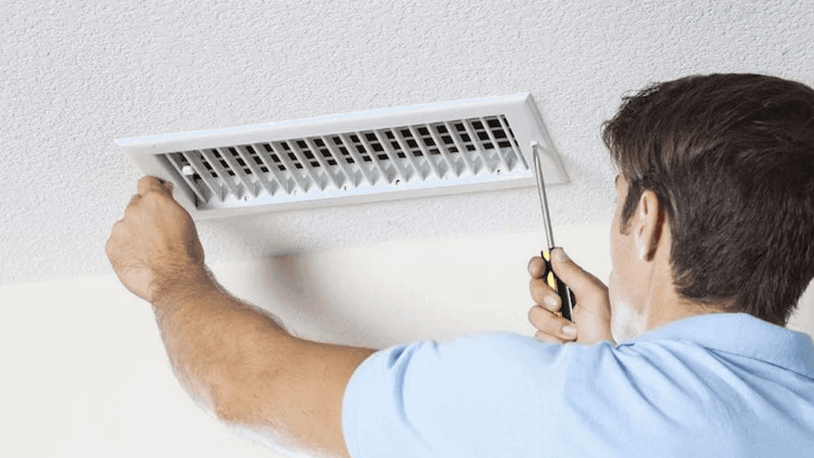Purified Air Duct Cleaning — technician removing a ceiling supply register
